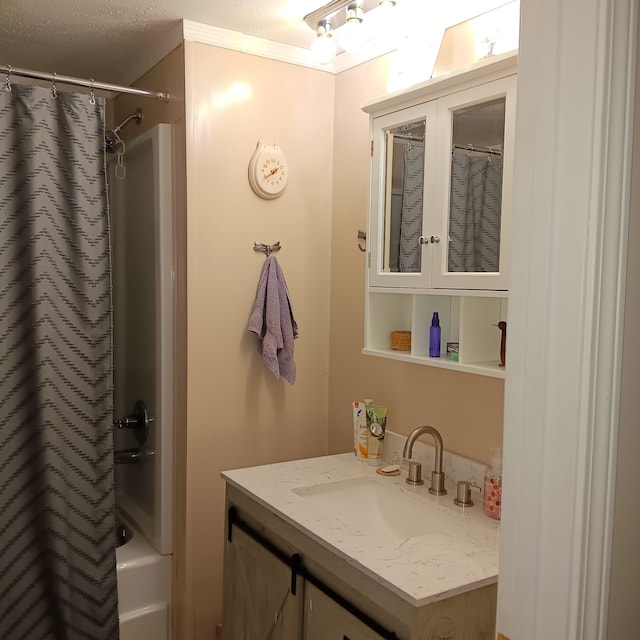 bathroom featuring vanity, a textured ceiling, shower / bathtub combination with curtain, and ornamental molding