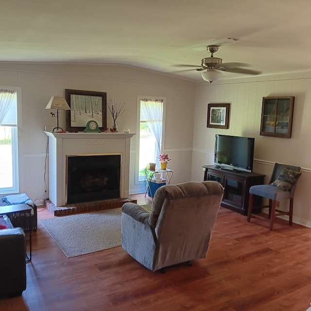 living room with hardwood / wood-style flooring, ceiling fan, vaulted ceiling, and a wealth of natural light