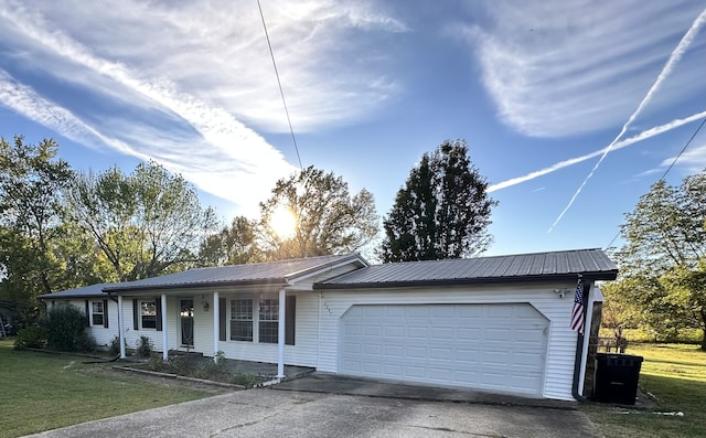 single story home featuring a front lawn and a garage