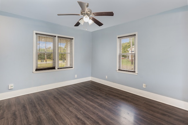 spare room with dark wood-type flooring and ceiling fan