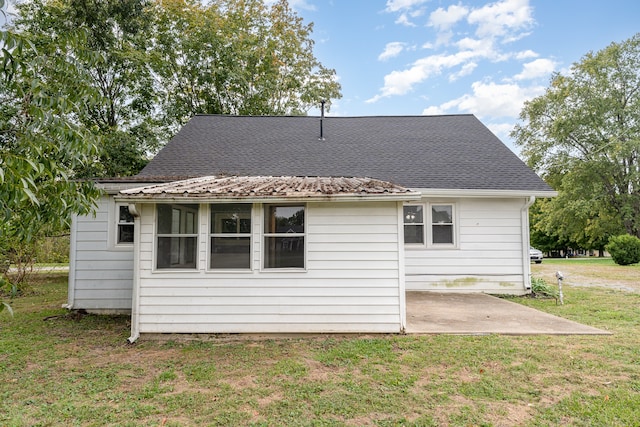 back of house featuring a patio and a yard