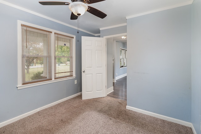 unfurnished bedroom featuring crown molding, carpet floors, and ceiling fan