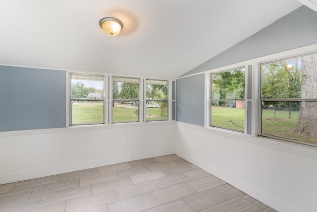 unfurnished sunroom with plenty of natural light and vaulted ceiling