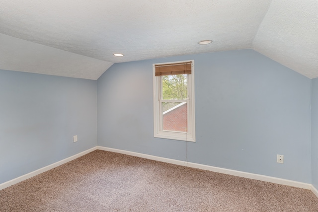 bonus room with lofted ceiling, a textured ceiling, and carpet floors