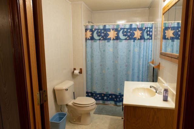 bathroom featuring vanity, toilet, walk in shower, and tile walls