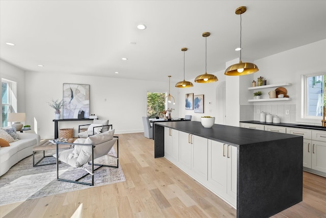 kitchen with white cabinetry, a healthy amount of sunlight, and hanging light fixtures