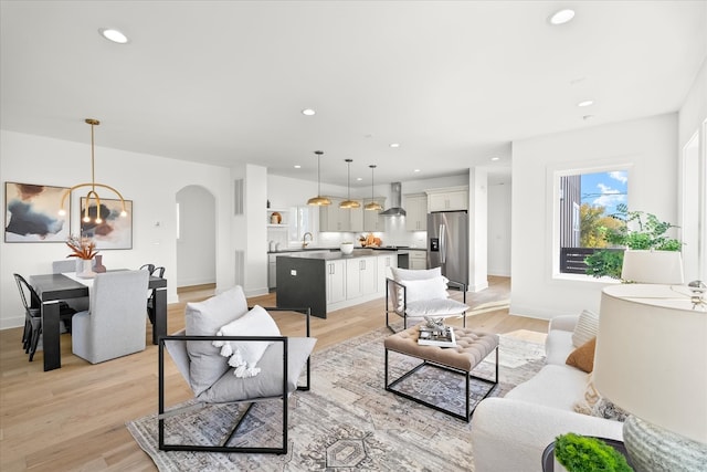 living room featuring light hardwood / wood-style flooring and sink