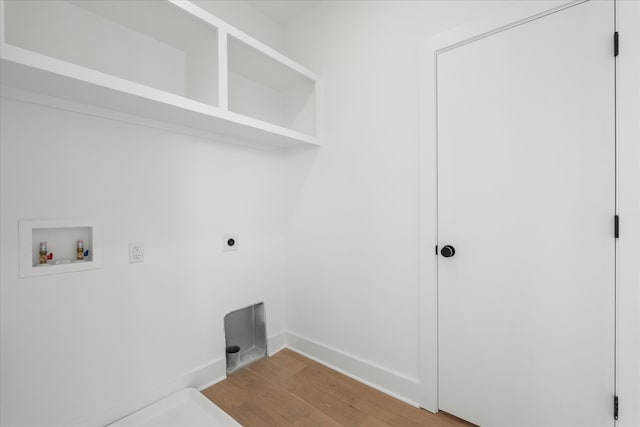 laundry area featuring electric dryer hookup, washer hookup, and light hardwood / wood-style floors