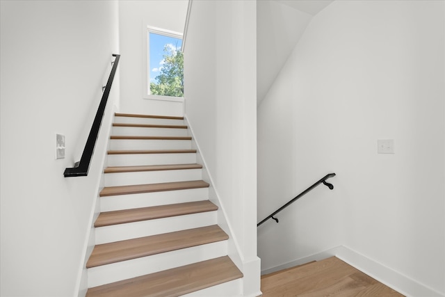 stairway featuring hardwood / wood-style floors