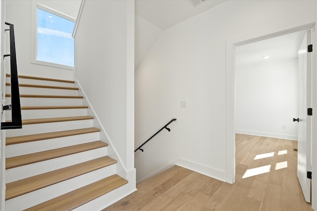 staircase featuring wood-type flooring