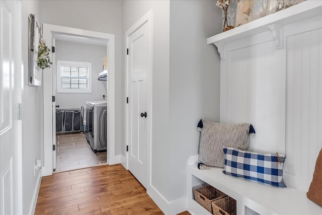 laundry area featuring hardwood / wood-style floors and separate washer and dryer