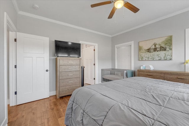 bedroom with ceiling fan, ornamental molding, and light hardwood / wood-style flooring