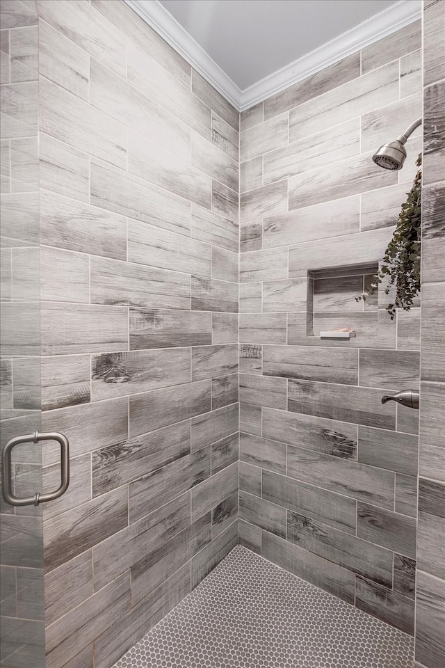 bathroom with crown molding and walk in shower