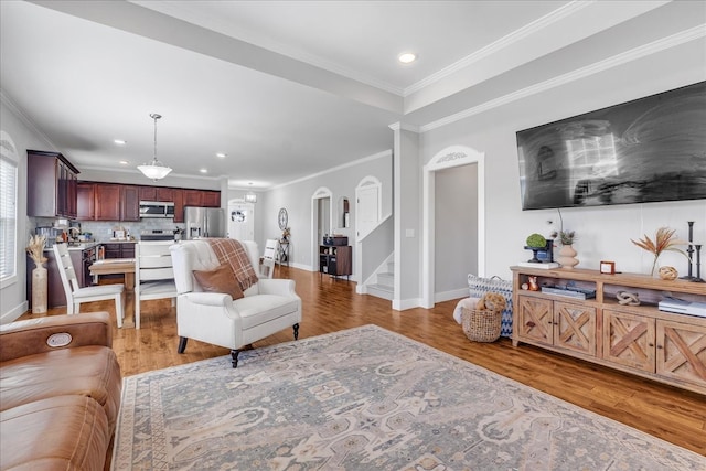 living room featuring crown molding and wood-type flooring