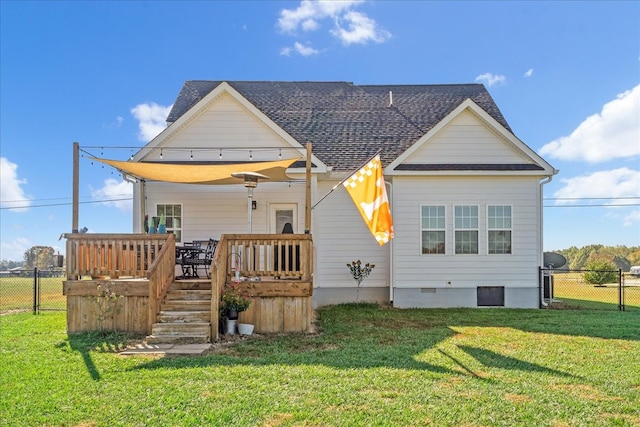 rear view of house with a deck and a lawn