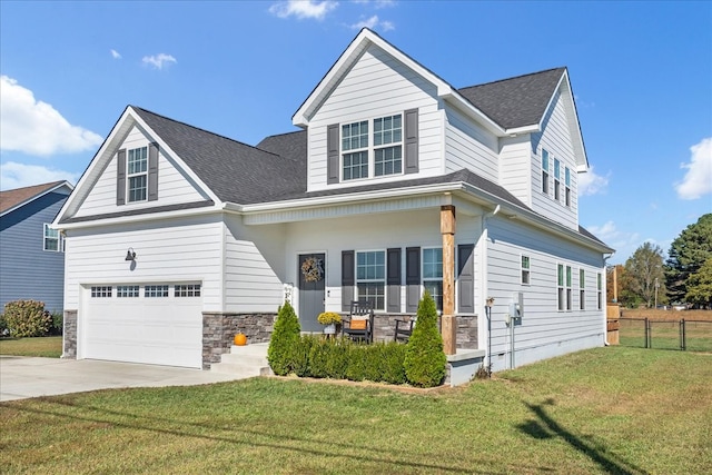 view of front of home featuring a front lawn, covered porch, and a garage