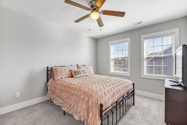 bedroom with ceiling fan and light colored carpet