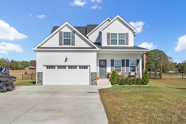 craftsman-style home with a front yard, a porch, and a garage