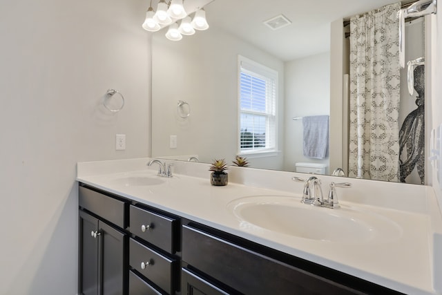 bathroom with toilet and vanity