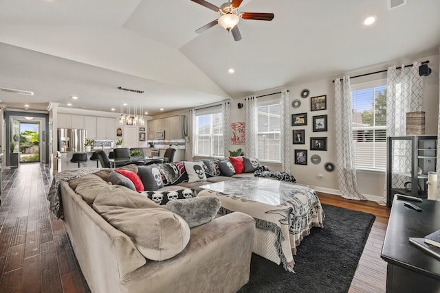 living room featuring dark hardwood / wood-style floors, ceiling fan, plenty of natural light, and vaulted ceiling