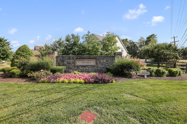 community sign featuring a lawn