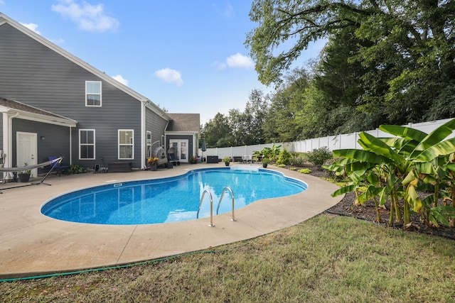 view of pool featuring a patio and a lawn