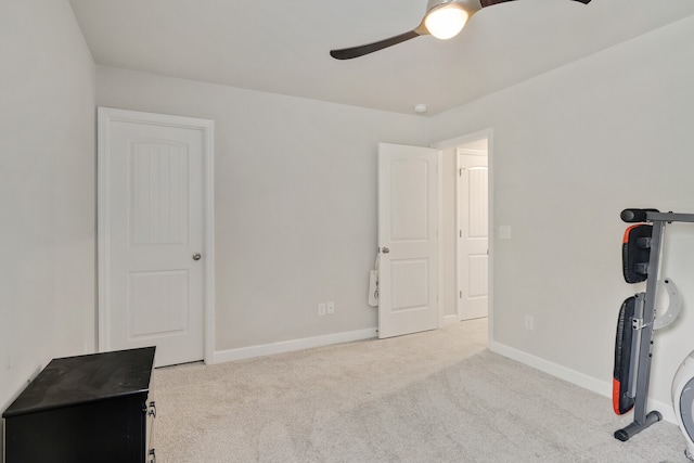 exercise area with light colored carpet and ceiling fan