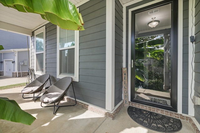 view of exterior entry with covered porch