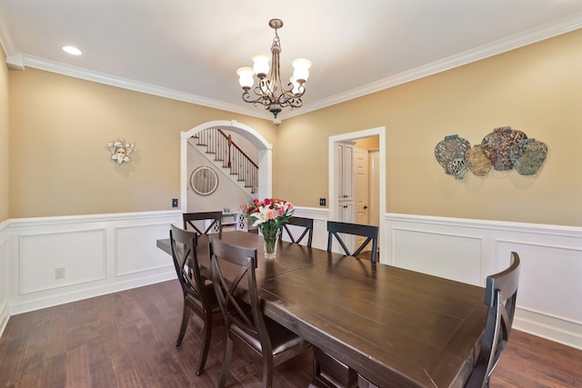 dining room with a notable chandelier, ornamental molding, and dark hardwood / wood-style flooring