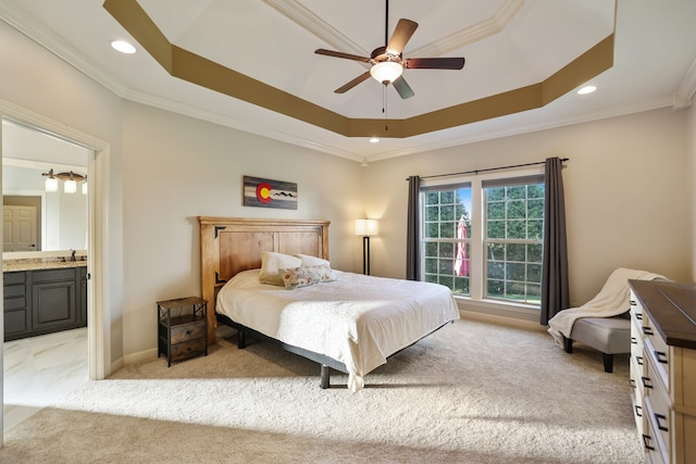 bedroom with ornamental molding, ensuite bathroom, light colored carpet, and ceiling fan