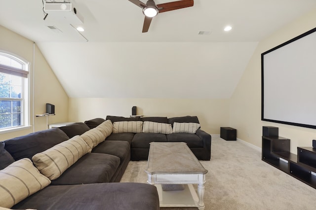 carpeted cinema with ceiling fan and vaulted ceiling