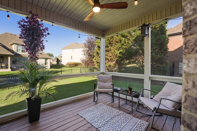 sunroom / solarium featuring ceiling fan