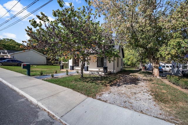 obstructed view of property with a front yard