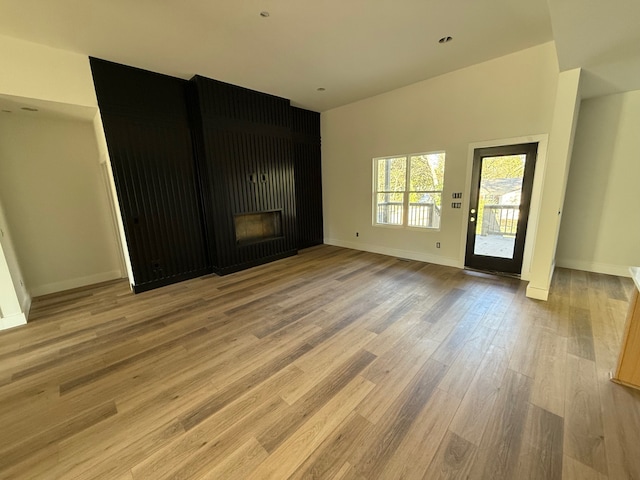 unfurnished living room with hardwood / wood-style flooring