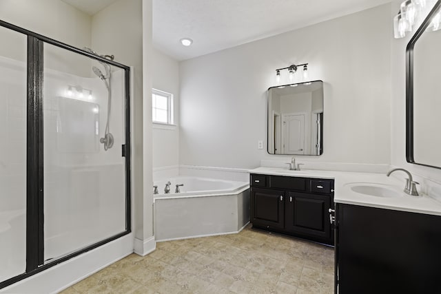 bathroom featuring vanity and shower with separate bathtub