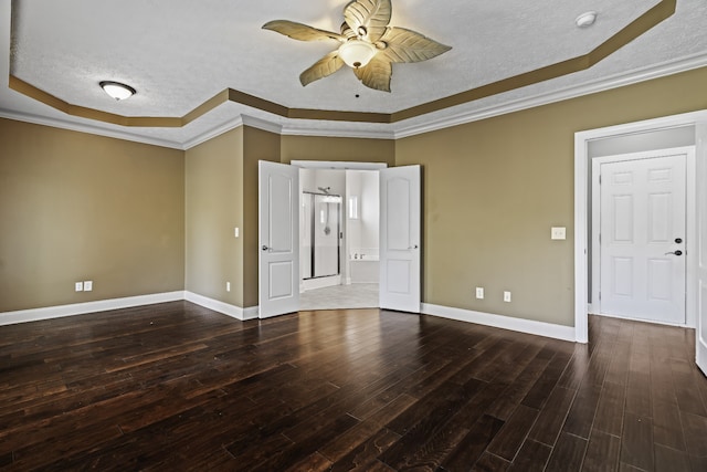 spare room featuring crown molding, a textured ceiling, and dark wood-type flooring