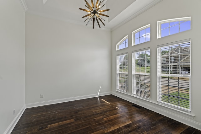 empty room with ornamental molding and dark hardwood / wood-style floors