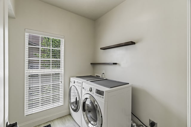 clothes washing area with washer and dryer