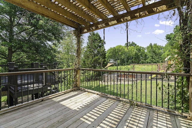 wooden terrace with a lawn and a pergola