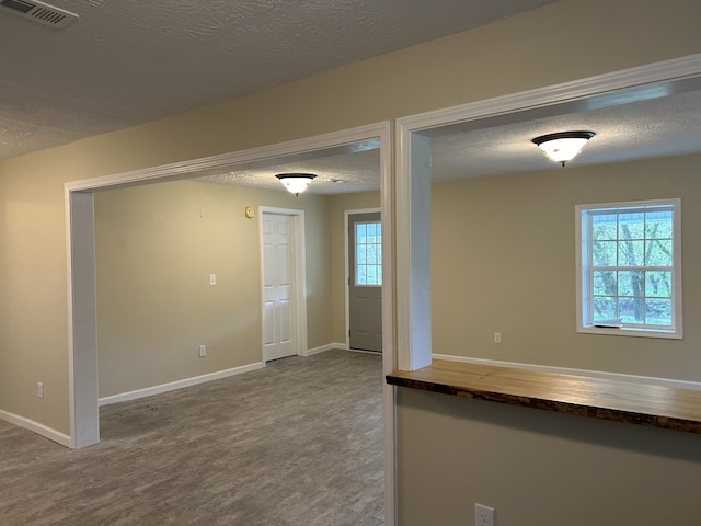 spare room featuring wood-type flooring and a textured ceiling