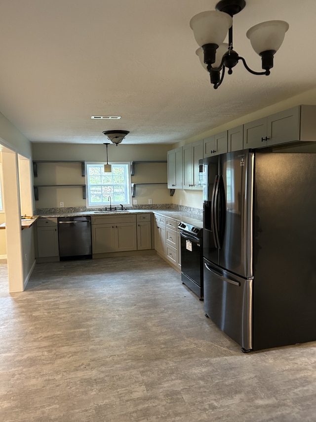 kitchen featuring light hardwood / wood-style flooring, sink, decorative light fixtures, gray cabinets, and appliances with stainless steel finishes