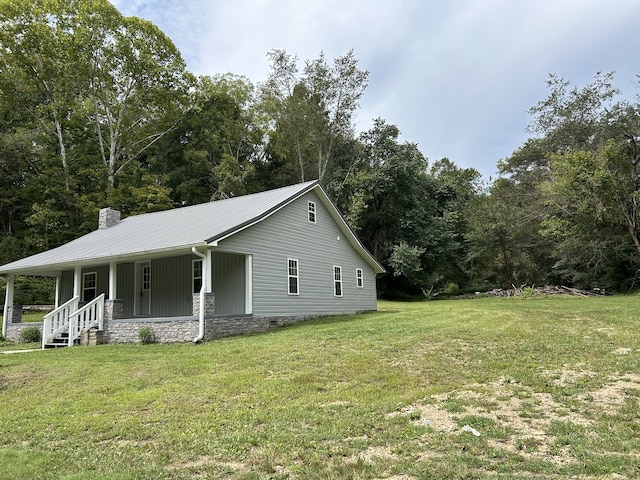 view of property exterior with covered porch and a yard