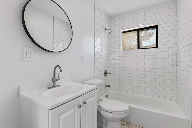 full bathroom featuring toilet, tiled shower / bath combo, and vanity