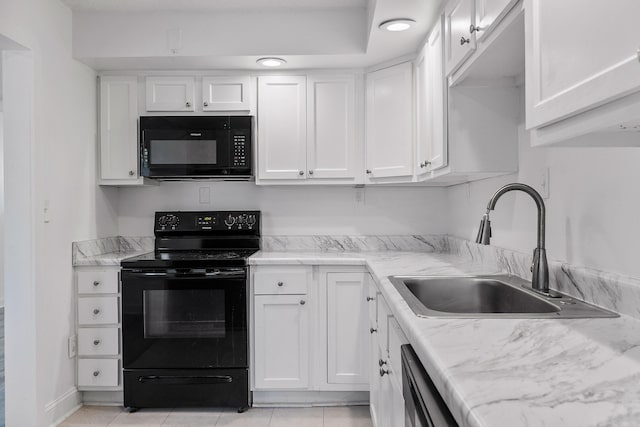 kitchen featuring sink, black appliances, light tile patterned floors, white cabinetry, and light stone counters