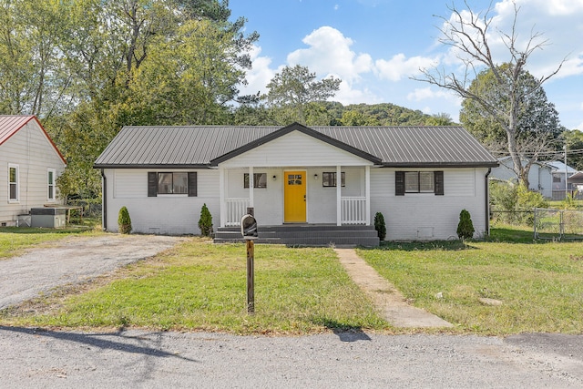 single story home with a front yard and a porch