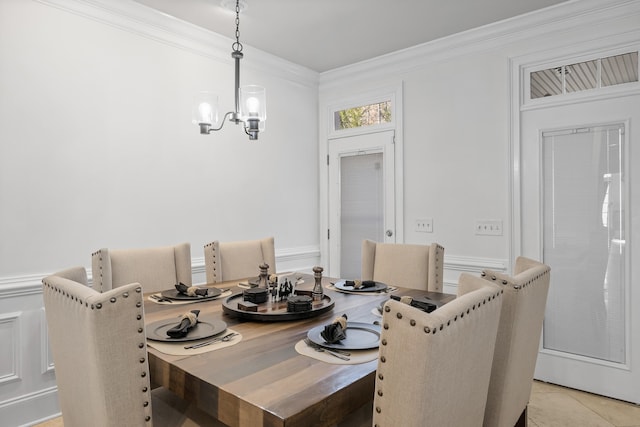 dining room with crown molding, a notable chandelier, and light tile patterned floors