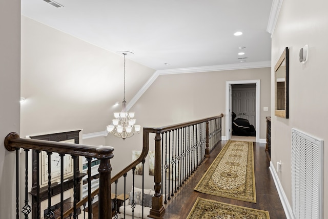 hallway with a chandelier, vaulted ceiling, crown molding, and dark hardwood / wood-style flooring