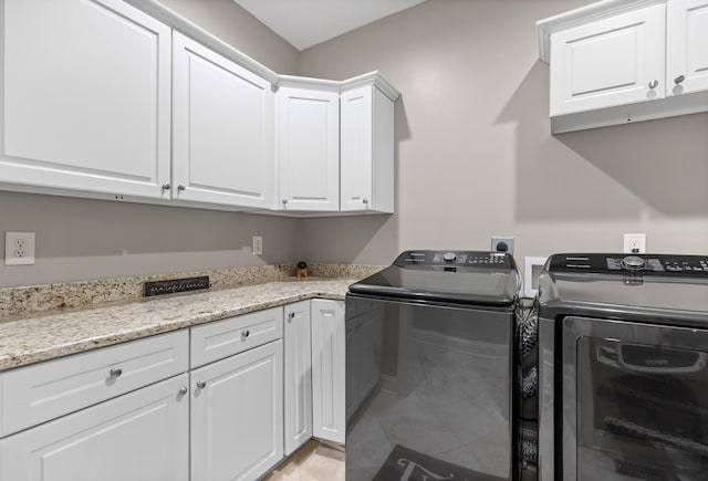 laundry area with cabinets and separate washer and dryer