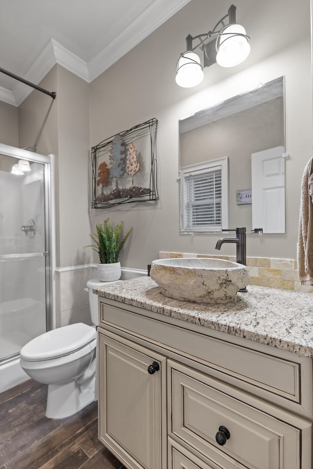 bathroom with walk in shower, hardwood / wood-style flooring, toilet, ornamental molding, and vanity