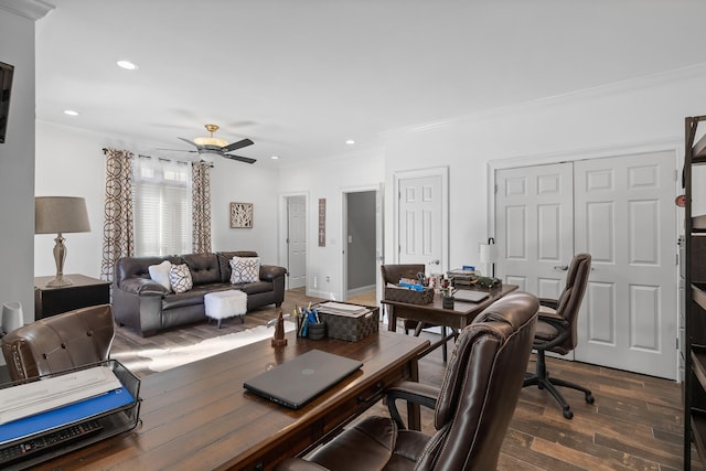 home office with dark wood-type flooring, ceiling fan, and crown molding